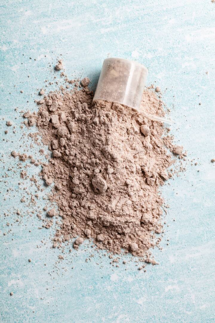 Scoop of Whey Protein in background. Sport nutrition.