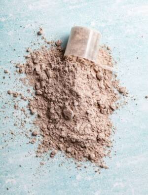 Scoop of Whey Protein in background. Sport nutrition.